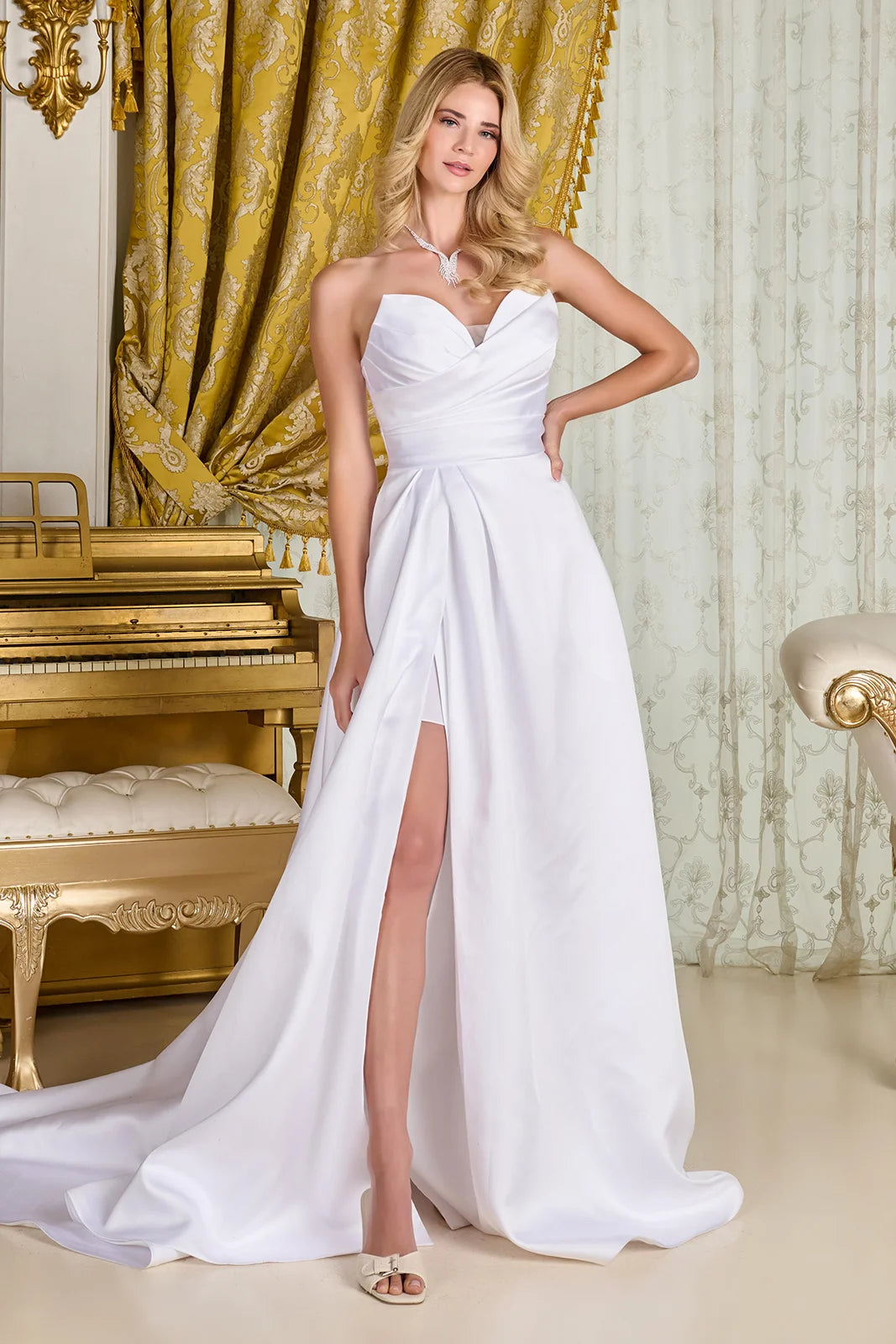 The flowing A-line silhouette showcases a wrap-over skirt