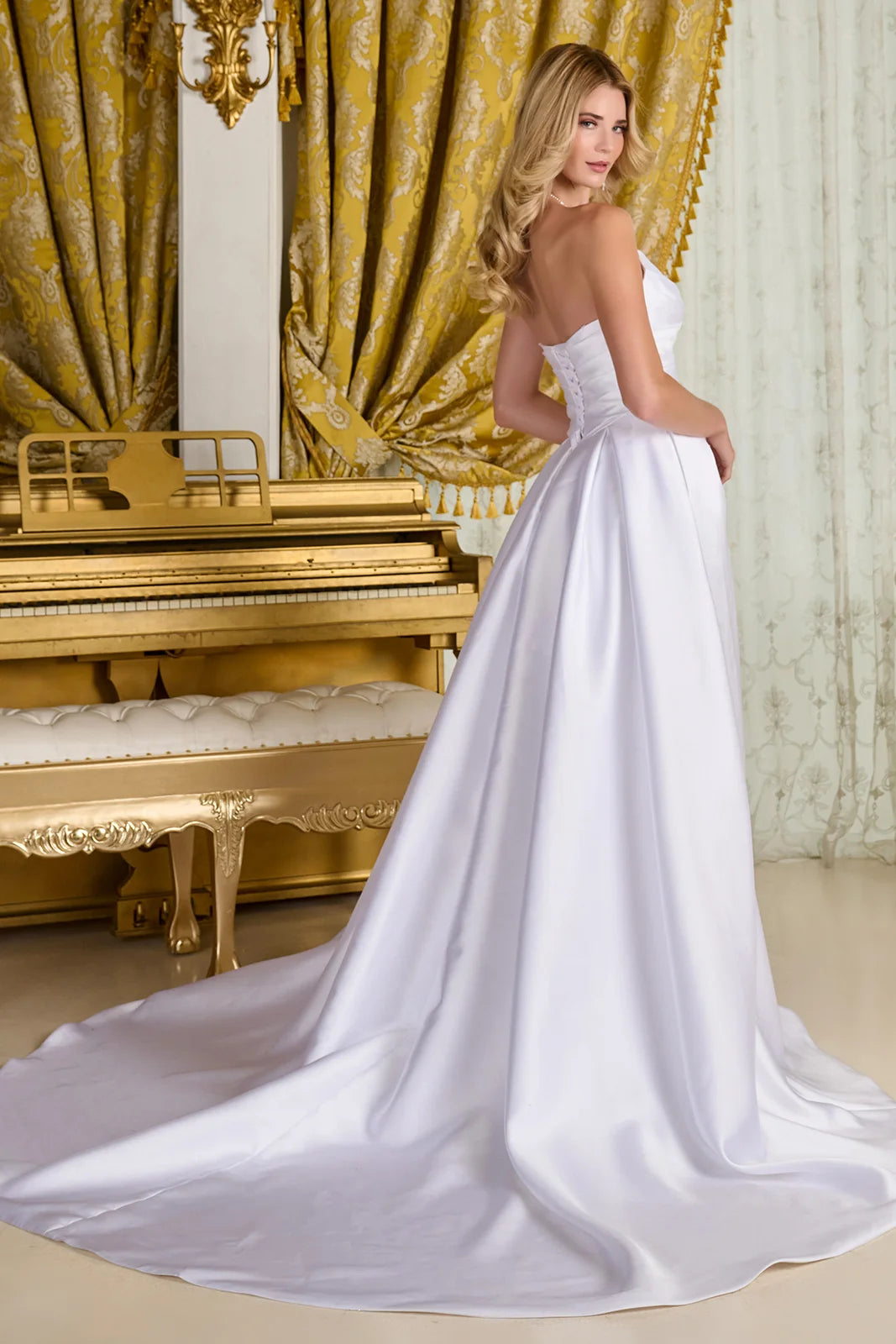 The flowing A-line silhouette showcases a wrap-over skirt